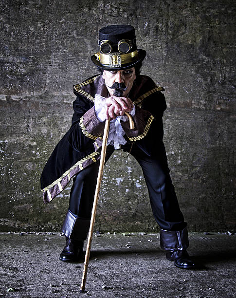istock man dressed in steampunk, victorian clothing, dark wall background 478077522