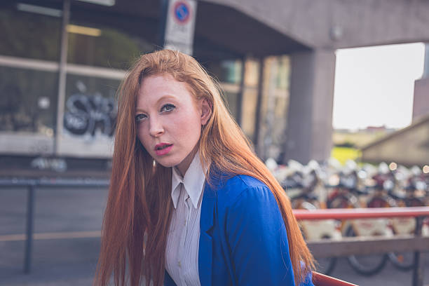 istock Beautiful redhead girl posing in an urban context 478077880