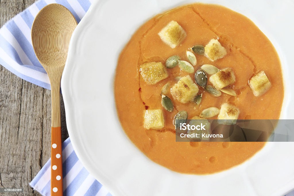 Pumpkin soup Delicious traditional homemade pureed pumpkin soup with seeds and croutons. Overhead view Autumn Stock Photo