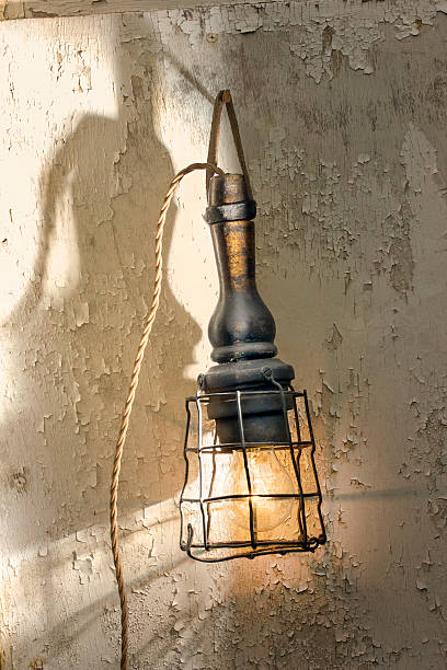 istock Vintage caged inspection lamp with flaking paint background 478085744