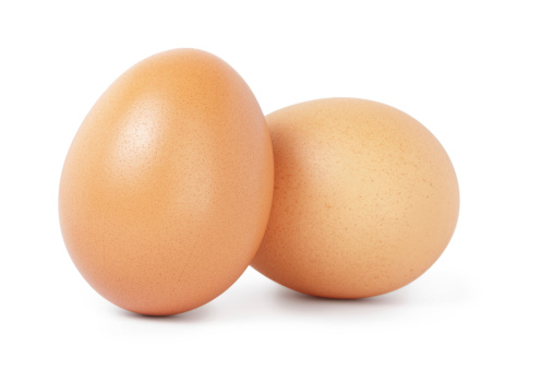 two brown chicken eggs, isolated on white background