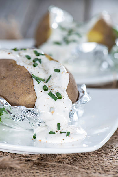 Baked Potatoe Baked Potatoe on vintage wooden background baked potato sour cream stock pictures, royalty-free photos & images