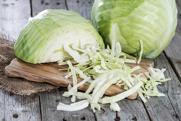 Portion of Coleslaw Portion of Coleslaw on wooden background white cabbage stock pictures, royalty-free photos & images