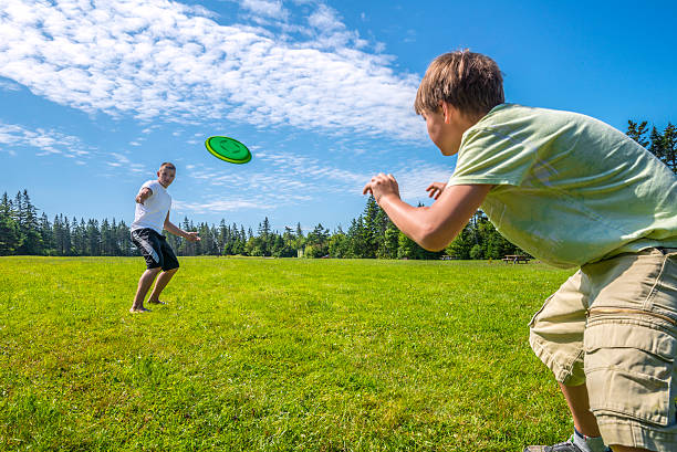 Boys playing a frisbee stock photo