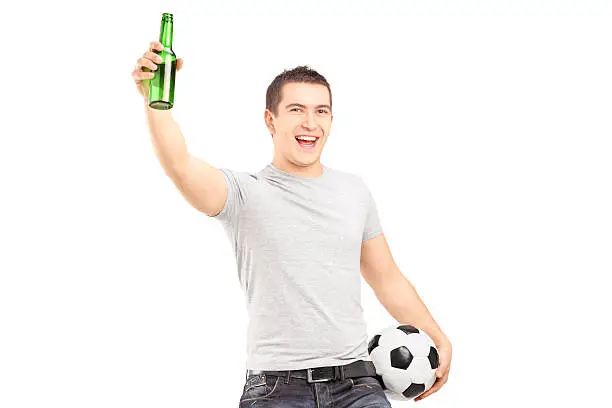 Photo of Euphoric sport fan holding a beer bottle and football cheering