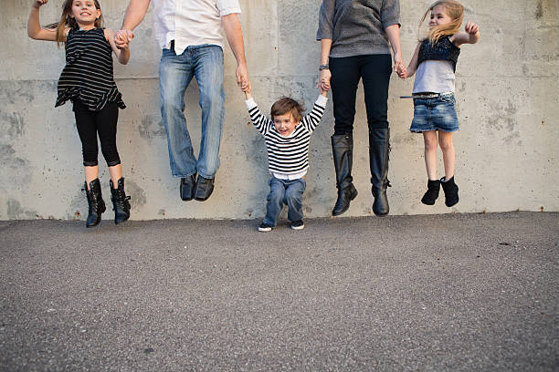 istock Father, Mother, Daughters, and Sons Jumping Outside 478096385