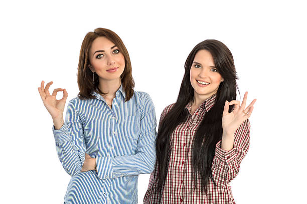 istock Two cheerful girls makes OK hand sign 478097608
