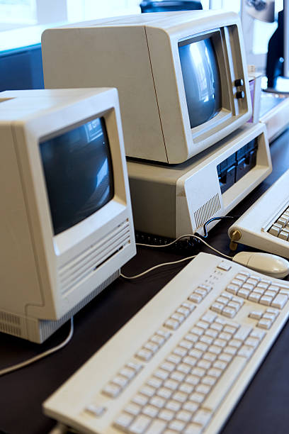 Two computers from the 1980s Two computers from the 1980s stand side by side in an office. computer mainframe old retro revival stock pictures, royalty-free photos & images