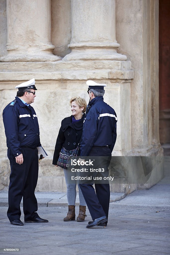 Woman chatting to two policemen Bologna, Italy - November 8, 2012: Woman chatting to two policemen in the town square in the city of Bologna Adult Stock Photo