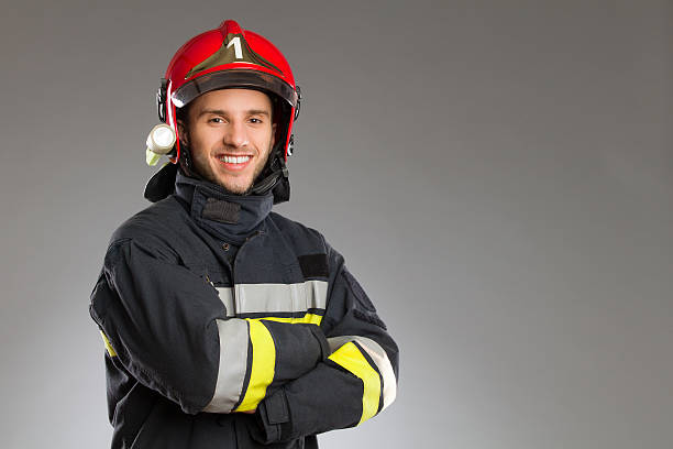 Cheerful firefighter with crossed arms. stock photo