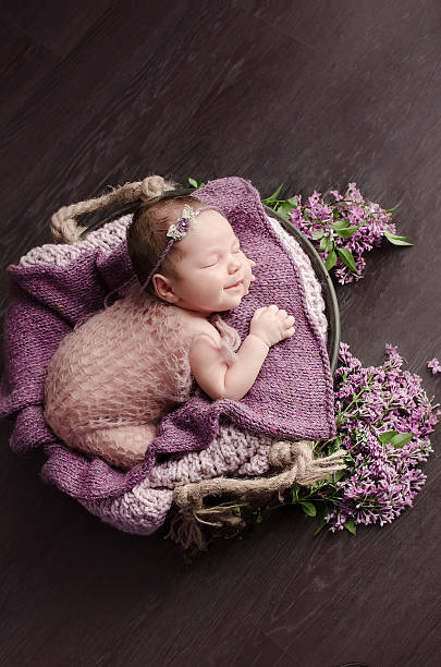 istock newborn girl and lilac 478107700