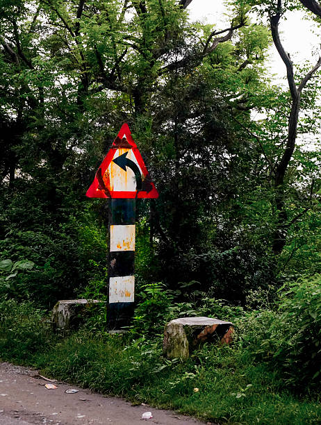 istock Old traffic sign bordered with trees, on a road side 478108605