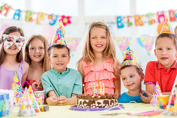 istock Smiling children at birthday party looking at camera. 478110584