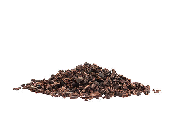 Raw organic cacao nibs isolated on white