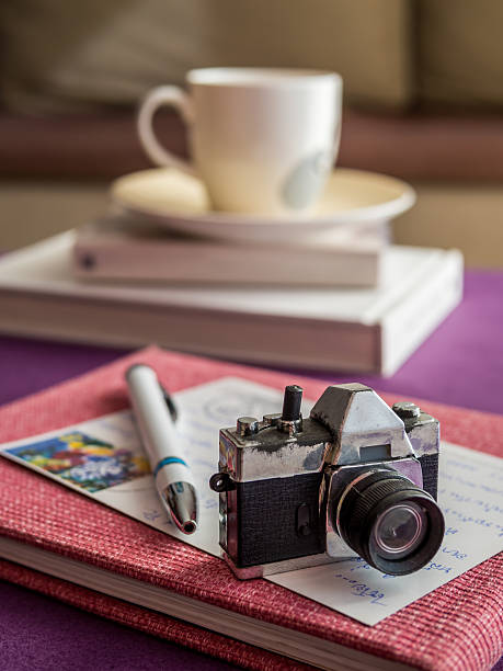 Colorful background as still-life with toy camera on postcard, book in modern room