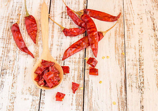 istock Dried chili peppers on wooden background 478117432