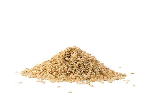 istock Pile of whole brown rice isolated on white 478117574
