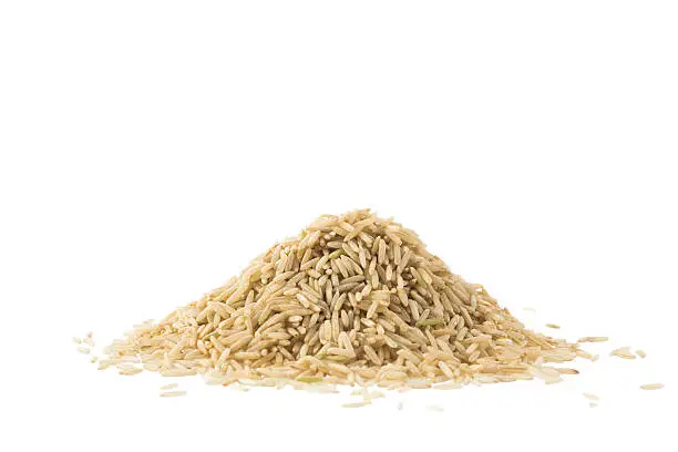 Pile of brown basmati rice isolated on white background