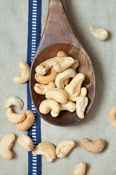 istock Cashew Nuts on wooden spoon 478120676