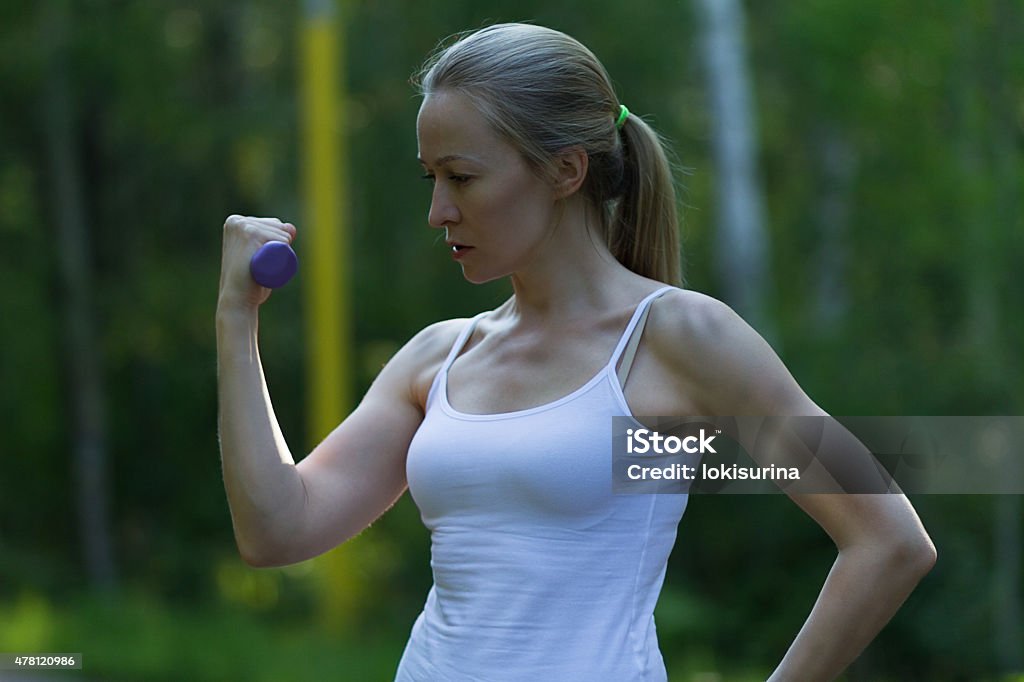 girl is engaged in fitness fitness, exercise with dumbbells, 2015 Stock Photo