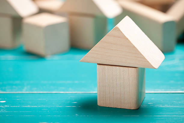 istock Wooden toy house on turquoise table 478121116