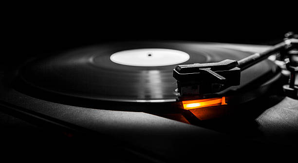 istock old style turntable with needle - b&w and orange light 478126861