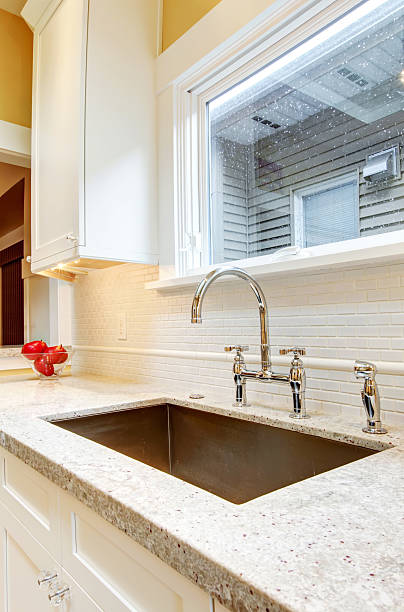 istock Large deep metal kitchen sink with granite countertops. 478127205