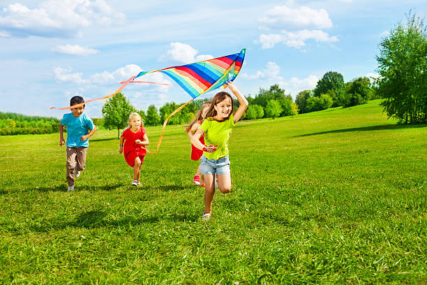 group of kids with kite - flying kite bildbanksfoton och bilder