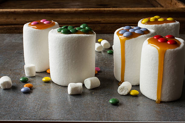 istock white marshmallow and caramel colored candies 478127948