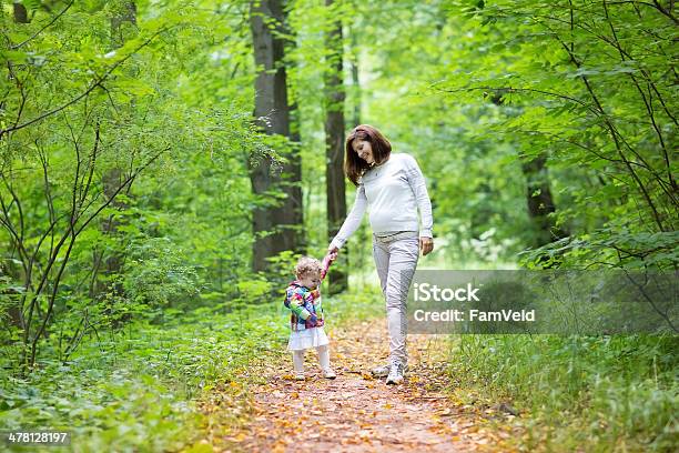 Beautiful Pregnant Woman And Her Baby Daughter Walking In Park Stock Photo - Download Image Now