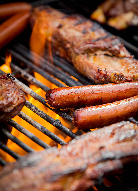 istock hot dogs and ribs on a grill 478130556