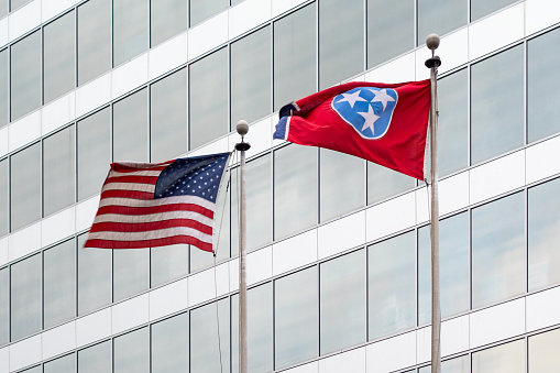 Photo of an office building in downtown Knoxville, Tennessee  with the US and Tennessee flags on poles.