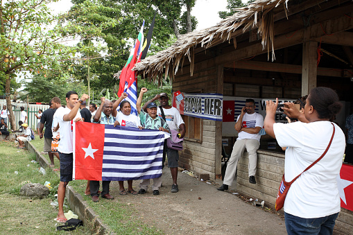 Honiara, Solomon Islands, June 18, 2015. A small group of men and women demonstrate for full membership of West Papua in the MSG (Melanesian Spearhead Group) holding a West Papua flag.