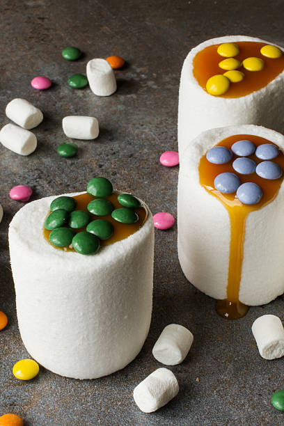 istock white marshmallow and caramel colored candies 478131760