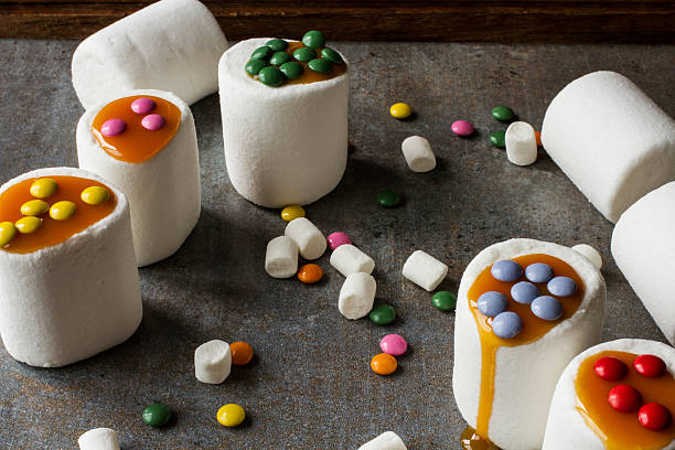 istock white marshmallow and caramel colored candies 478131764