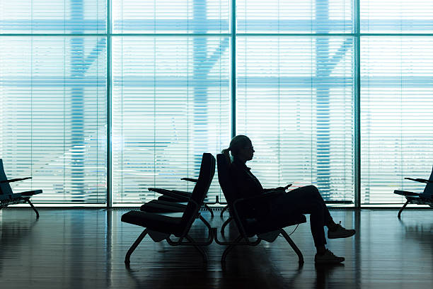 istock Woman in transit waiting on airport gate. 478134596