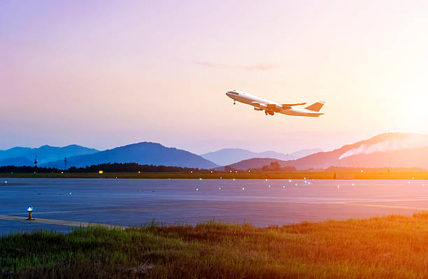 passenger plane fly up over take-off runway stock photo