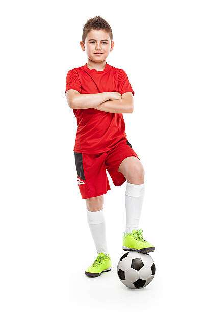 istock standing young soccer player with football 478142396