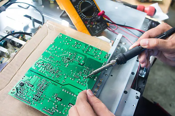 Technician repairing  a television.