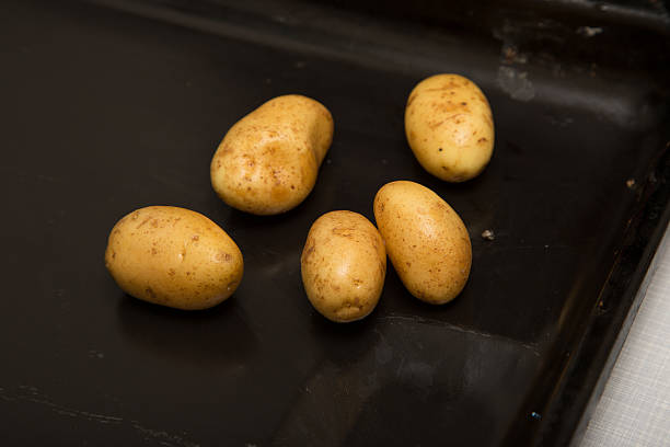 istock Shiny fresh potatoes on an oven plate 478147842
