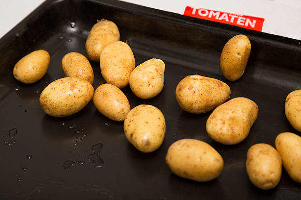 istock Shiny fresh potatoes on an oven plate 478147844