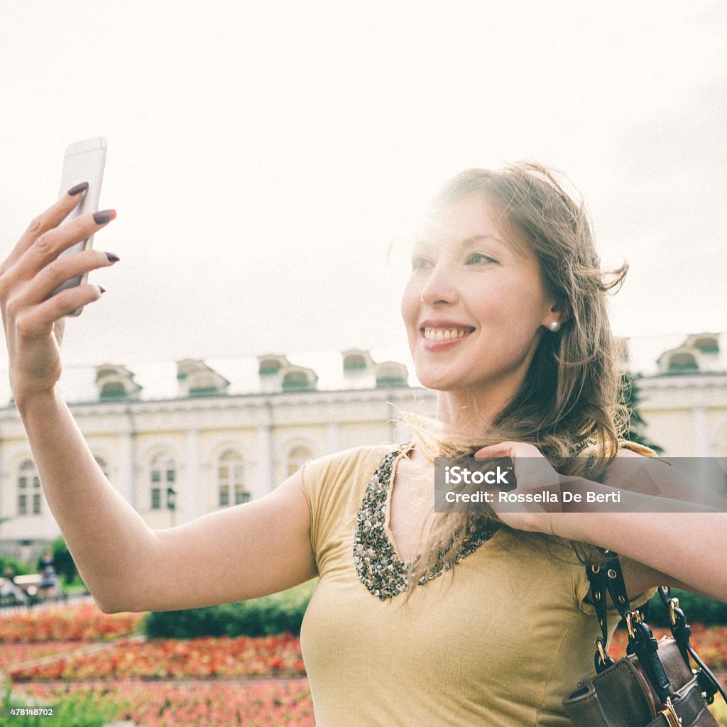 Cheerful Woman Taking A Selfie, Alexander Garden, Moscow, Russia Cheerful Woman Taking A Selfie, Alexander Garden, Moscow, Russia. 2015 Stock Photo