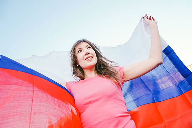 istock Cheering Woman Under Russian Flag 478148718