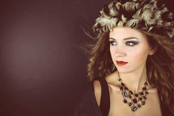 istock Young woman wearing feather hat 478151544