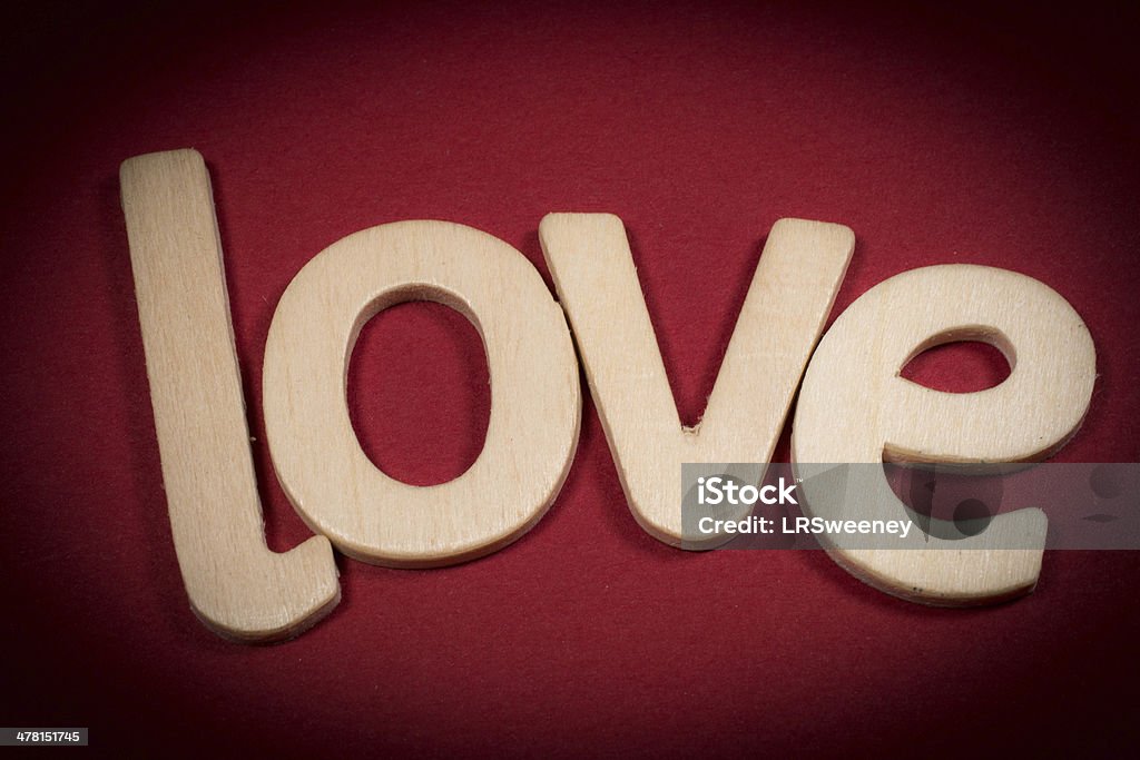 The word LOVE in wooden letters on red background Alphabet Stock Photo
