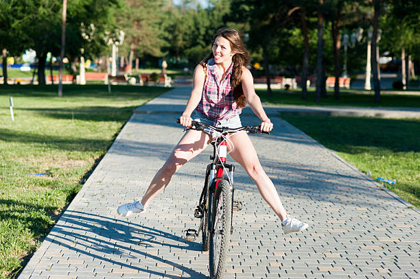 istock Smiling girl riding on bicycle 478154124