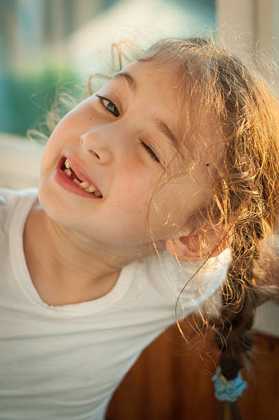 istock Cute little girl winking 478154630