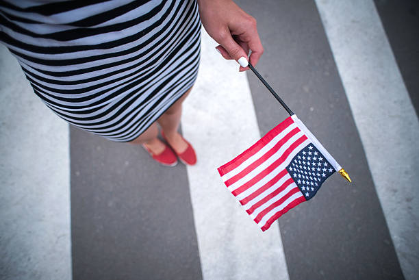 istock woman hand holding american flag 478158622