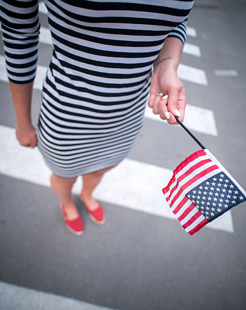 istock woman hand holding american flag 478158640