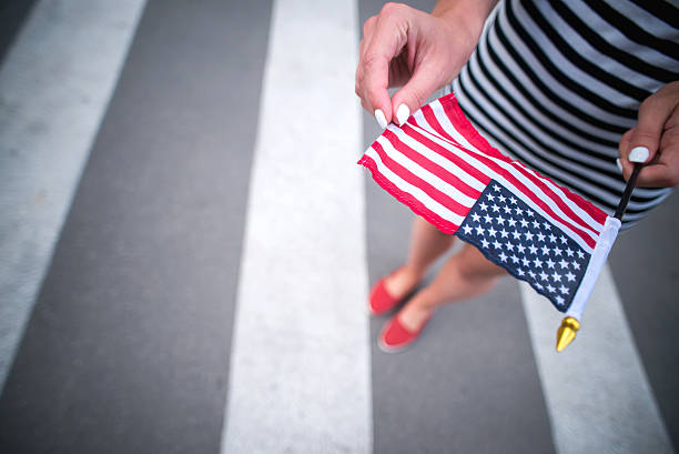 istock woman hand holding american flag 478158644